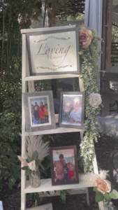 Wooden ladder with pictures and sayings in memory of loved ones that have passed at the entry of the reception barn at All4One Farms in Jacksonville, FL.